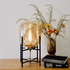 glass table lamp beside books